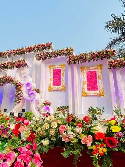 A close-up of the abundant flowers lining the base of this beautiful multi-layered wedding stage.