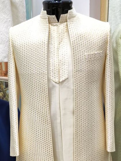 Another view of the classic open sherwani jacket in a textured cream fabric, showing its clean lines and sophisticated design from a different angle.