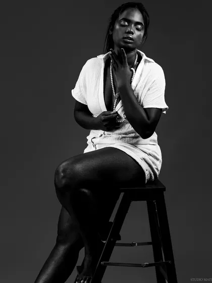 A powerful monochrome portrait that uses shadow and light to create a dramatic, soulful mood. This is an example of my work celebrating diverse beauty in a classic, honest style.