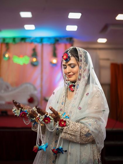A portrait of a beautiful bride during her Muslim Mehendi ceremony. The floral jewellery and her serene expression make for a stunning and culturally rich photograph.