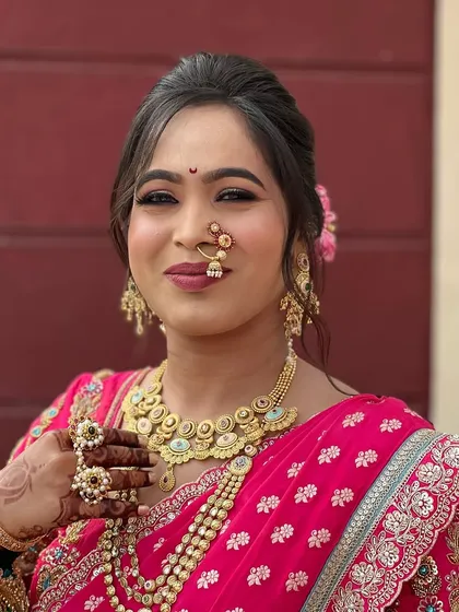 This bride's happy expression is framed by a soft, messy updo, proving that traditional wedding hairstyles can also feel comfortable and contemporary.
