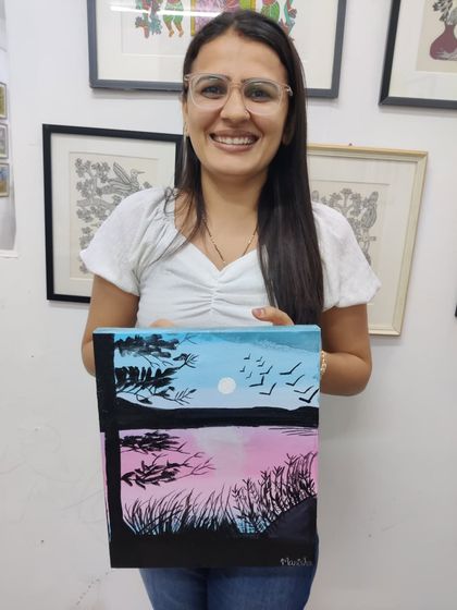 A collection of happy students from our adult canvas painting workshop, each holding their unique and beautiful landscape and abstract creations.