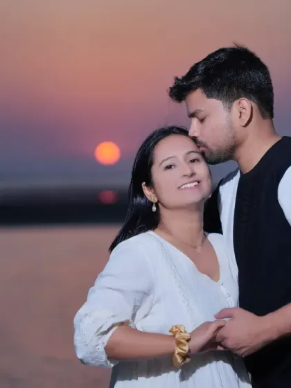 An intimate sunset moment during a beach pre-wedding shoot. The warm glow of the setting sun creates a perfectly romantic atmosphere for tender couple portraits.