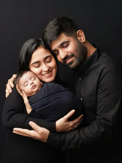 The whole family wrapped in a group hug, centered around their new baby. This pose is all about warmth, security, and the love that binds a new family.