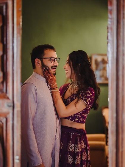 An intimate moment framed by an antique doorway, the couple's expressions full of love and happiness.