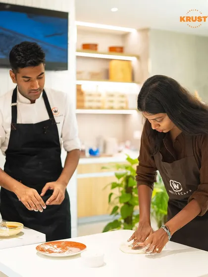 You're never alone in the kitchen here. This shot captures one of our professional chefs guiding a participant through the process of kneading pizza dough, ensuring you learn the right techniques from the start.