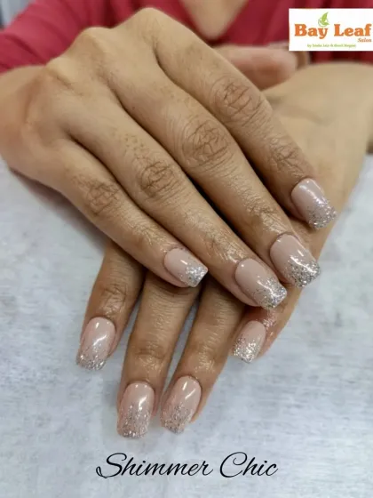 Shimmer and chic go hand in hand. These square-tipped nail extensions feature a neutral, natural base with a beautiful silver glitter gradient on the tips for an elegant sparkle.