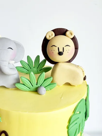 A close-up of the friendly lion topper from the jungle cake. I focus on making the characters cute and approachable for the little ones.
