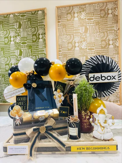 We curated this bold black and gold themed hamper for a new office inauguration. It sets a tone of confidence and prosperity with a Ganesha idol for blessings, a live plant for growth, a personalized diary for new ideas, and the company's logo for a bespoke corporate touch.