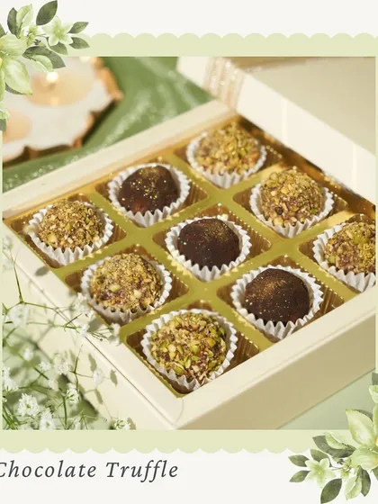 A box of our decadent chocolate truffles, some coated in pistachio and others dusted with cocoa. These are a perfect, indulgent gift or a treat for yourself.