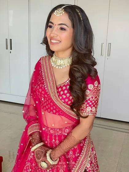 A portrait of the Sabyasachi bride, her hair styled in timeless, glamorous waves.