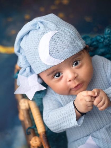 This baby boy's curious expression is priceless. The moon and stars theme provides a magical backdrop for capturing these wonderful awake moments.