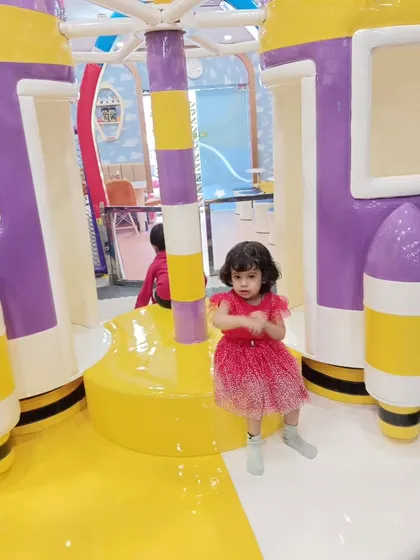 A student from Purplekidz Pre-School enjoying our rocket-themed merry-go-round during their fun-filled school picnic.