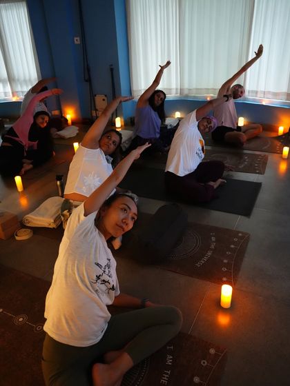 The serene ambiance of a candlelight yoga class. This practice is perfect for winding down and turning your focus inward.