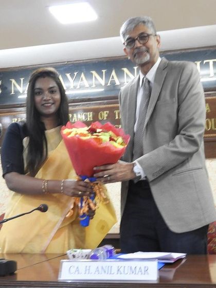 Receiving flowers at the workshop, a gesture of appreciation for sharing my knowledge on financial auditing.