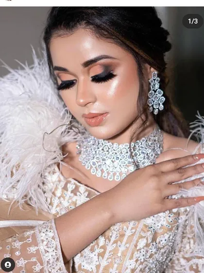 Make a statement at your next party without the hefty price tag. This stunning ivory lehenga with delicate embroidery and dramatic feather details is a perfect example of our unique party wear collection available for rent.