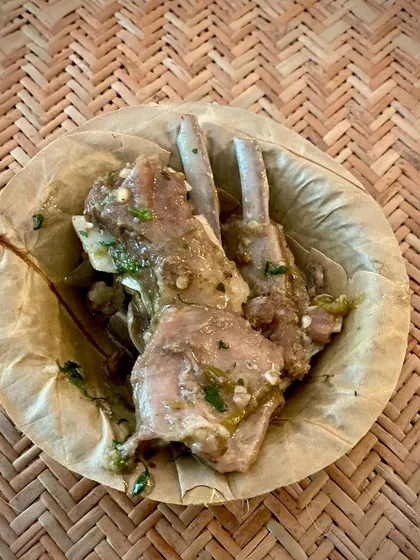 My slow-cooked Bannur lamb riblets, served simply in a leaf bowl. The meat is so tender it falls right off the bone, a result of cooking it slowly in its own fat.