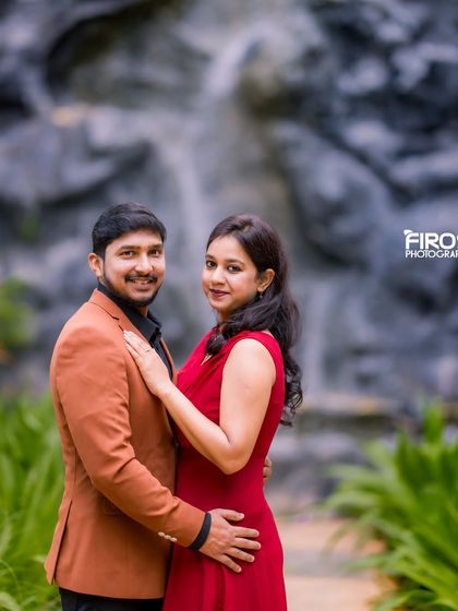 A classic couple's portrait in front of our waterfall backdrop, a popular spot for adding a touch of nature's drama to your photos.