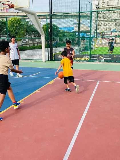 A young player learns to dribble while looking up, an essential skill for court vision.