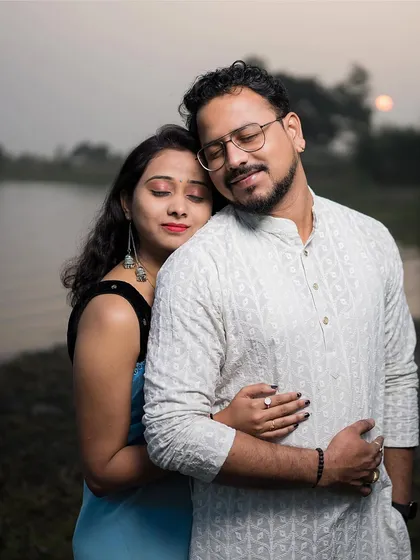 A peaceful embrace by the lake at dusk. The soft, fading light is perfect for capturing serene and emotional pre-wedding moments.