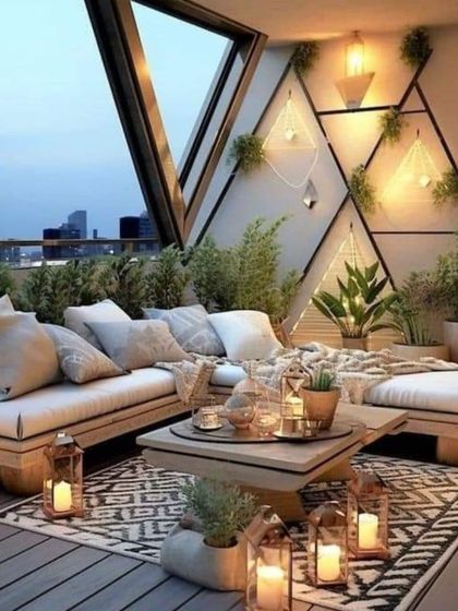This spacious balcony design uses low wooden seating, plush cushions, and numerous lanterns to create a bohemian-chic lounge area, perfect for hosting friends or relaxing under the stars.
