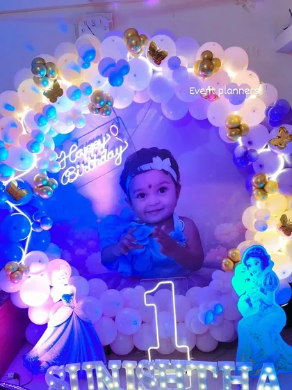 A beautiful princess-themed first birthday with a photo backdrop and butterfly accents.
