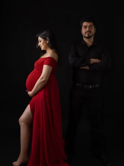 A more modern, fashion-inspired pose for the couple, showing versatility in styling even with a simple black backdrop.
