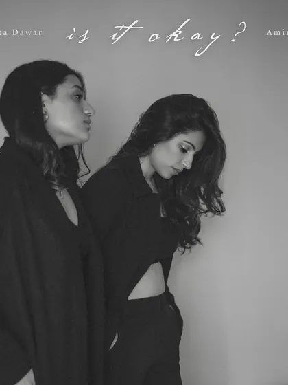 The album artwork for 'Is It Okay?'. This black and white portrait of Amira and Anahita captures the vulnerability and courage of their music.