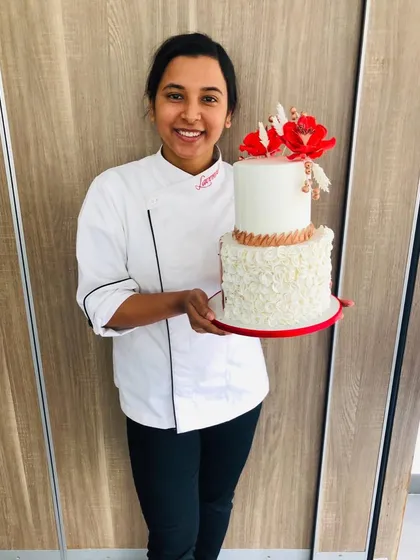 This is me, Megha, the heart behind The Bake House. Holding one of my creations reminds me of the journey from an MBA graduate to a full-time pastry chef, and I'm so grateful to be a part of your celebrations.