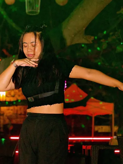 A guest showing off her dance moves under the green lights.
