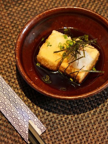 A quiet moment with a bowl of our Agedashi Tofu. The combination of the hot, savory broth and the soft, crispy tofu is the definition of Japanese comfort food.