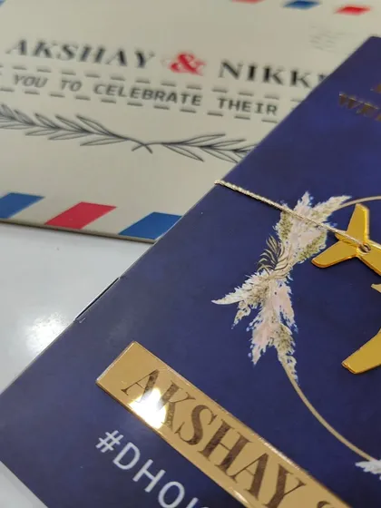 Your adventure together starts here. I designed this passport-style invitation for a travel-loving couple, complete with a golden acrylic airplane cutout and a boarding pass insert for the event details. It's a fun and creative way to invite guests to a destination wedding.