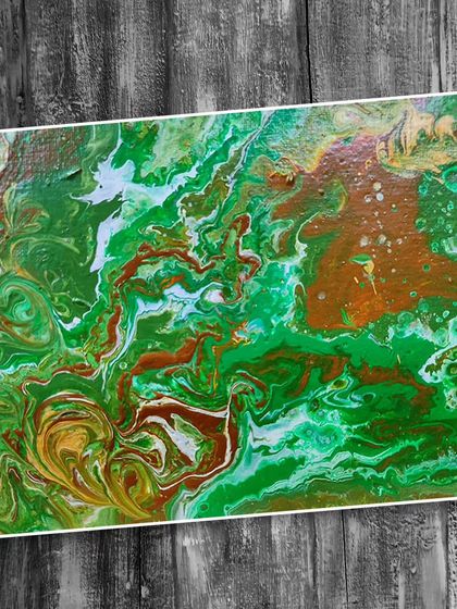 An example of fluid art created in our class, featuring a dynamic blend of green, brown, and white acrylics to create an earthy, abstract pattern.