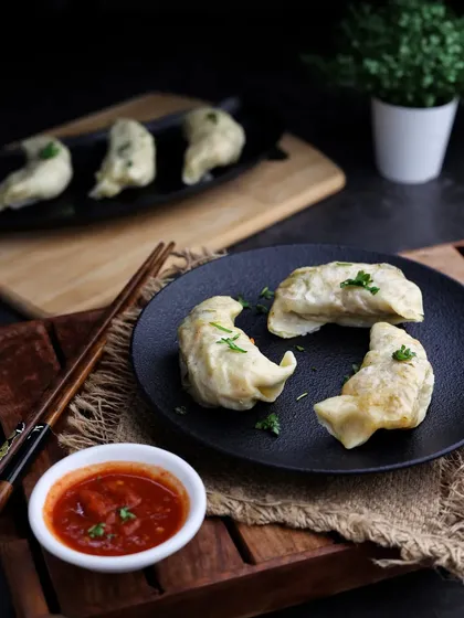 Wednesday Mo(mo)tivation. A simple, elegant shot of pan-fried momos with a spicy dipping sauce.