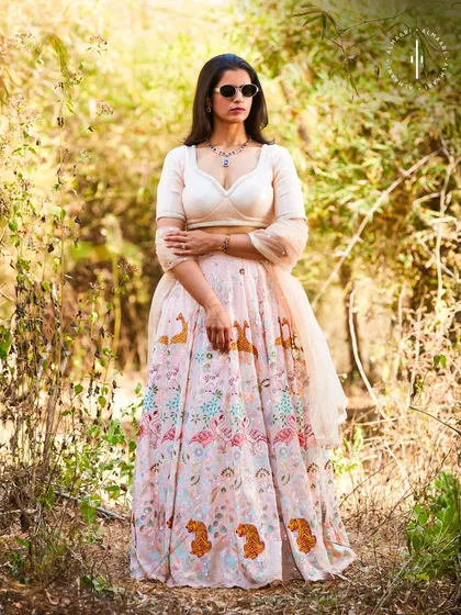 Here's another angle of the printed lehenga, showing how beautifully it moves. We styled it with modern sunglasses and a simple necklace to let the outfit do the talking.