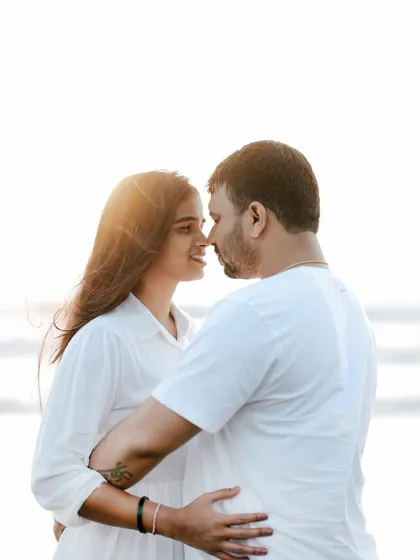 A close-up shot focusing on the couple's connection as they look at each other, with the bright sun creating a beautiful flare.