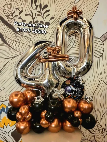 A 40th birthday number bouquet in black, silver, and rose gold.