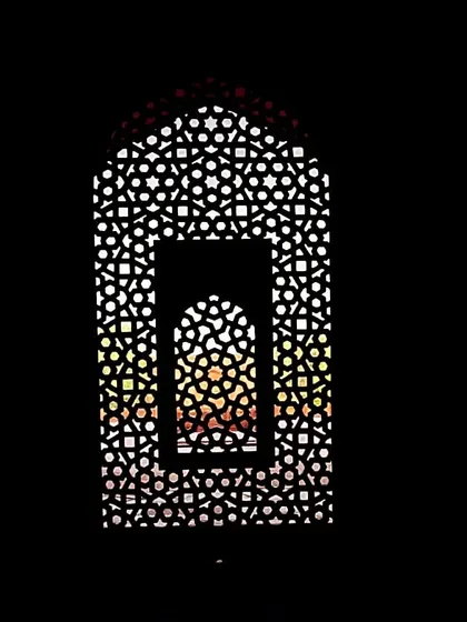 A creative view through a jali screen at Humayun's Tomb, framing the sunset colors outside. It's a perfect example of how Mughal architects played with light and perspective.