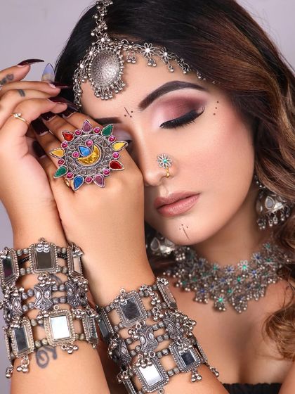 The full boho ensemble, featuring layered silver bracelets and a relaxed, wavy hairstyle.