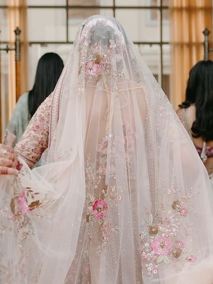 The bride's veil, intricately embroidered with floral details that echo the decor of her wedding. We believe in creating a cohesive story that extends to every element, including bridal styling.