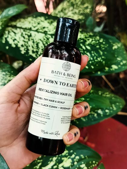 My Down to Earth Hair Oil is a revitalizing blend of over ten cold-pressed oils, including amla, brahmi, and black cumin seed. It's formulated to reduce hair fall, promote growth, and tackle scalp issues.