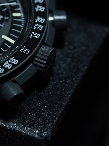 A close-up of the tachymeter scale and crown on the "Mission to Mercury." The design is a faithful tribute to the original Omega Speedmaster.