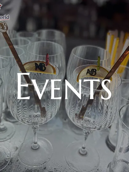 A collection of empty glasses, ready for an event, featuring custom-branded stirrers. We ensure every element of the bar service, down to the smallest detail, reflects your personal style.