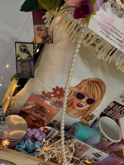 A look inside the Taylor Swift cart, showing the custom pillow, mug, scrunchies, and other themed goodies packed with care.