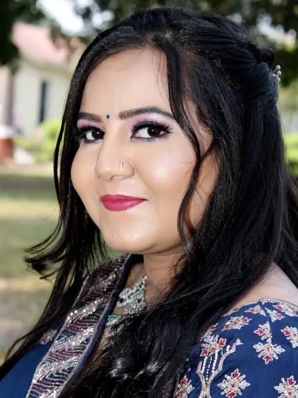 A close-up of an engagement look. The makeup features a pop of color on the eyes and a bold berry lip, perfect for an outdoor photoshoot.