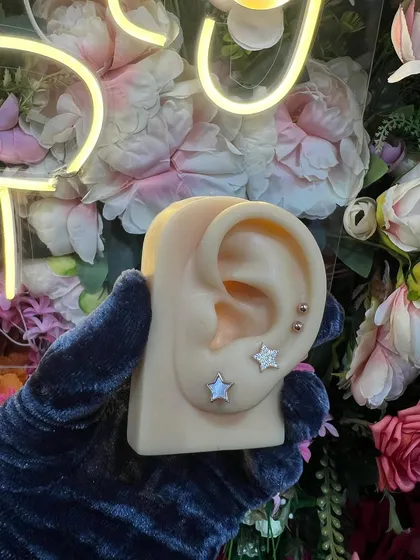A minimalist ear stack with two simple star studs, showing that less can be more.