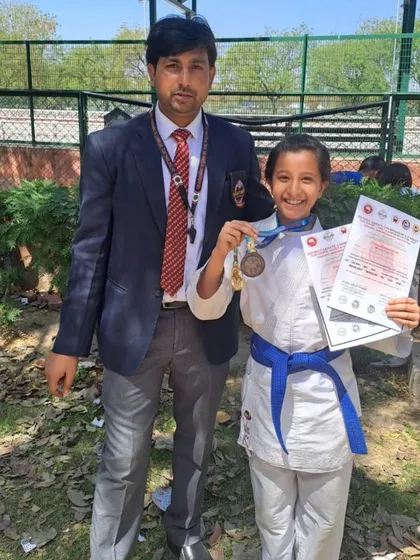 Posing with a happy student and her medal after the Gautam Buddh Nagar district championship.