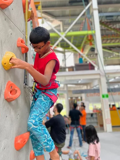 Another climber enjoying our cool, air-conditioned gym. It's the perfect place to stay active and have fun, especially during the hot summer months.