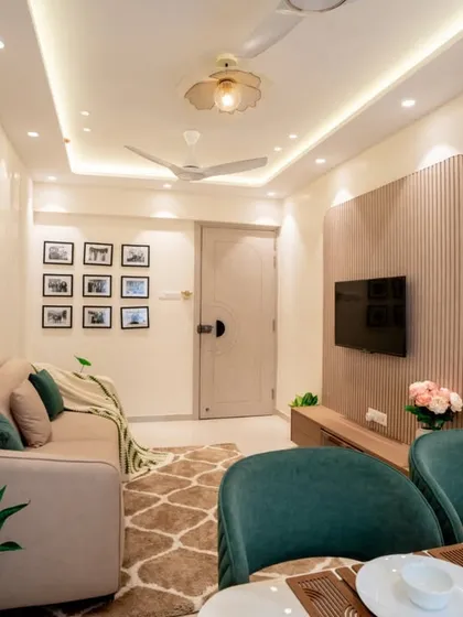 A warm and inviting living space with soft, earthy tones. The design includes a custom wall niche for decor, a comfortable beige sofa, and a dedicated, beautifully lit altar, creating a serene and personal atmosphere.