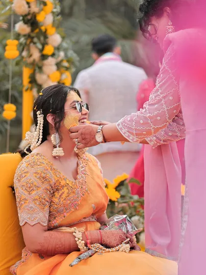 A beautiful candid shot of the bride during her Haldi ceremony, her face glowing with happiness.